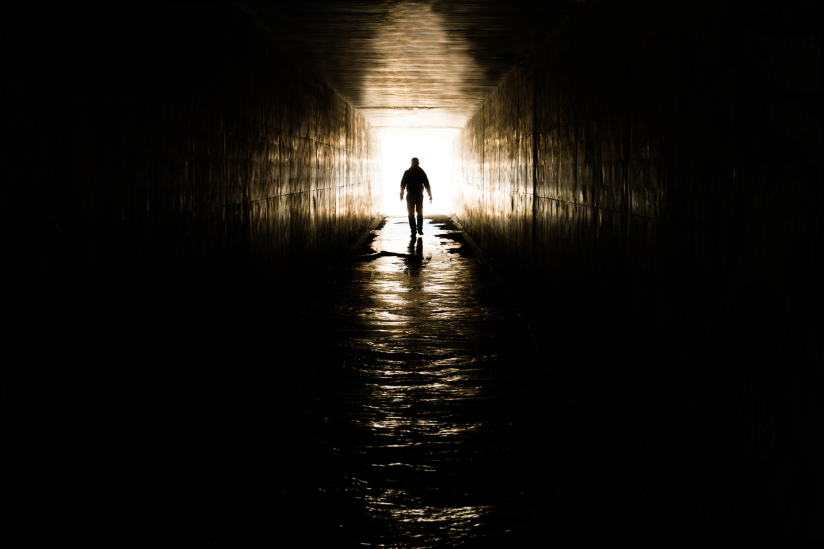 Man Walking Towards Cross